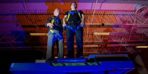 two men standing on raised platform