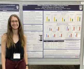 Emma in front of poster