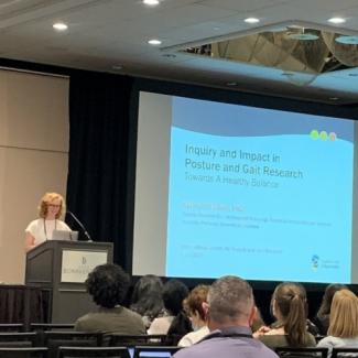 Katy presenting at a podium