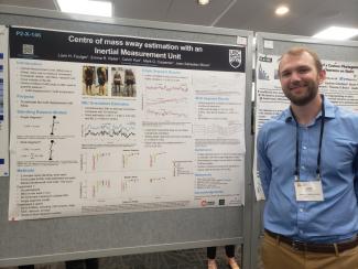 Liam in front of poster