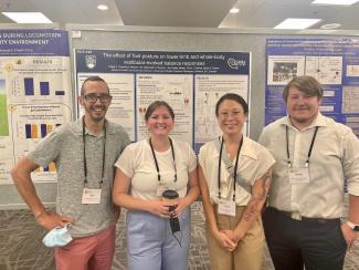 Paige and colleagues in front of poster
